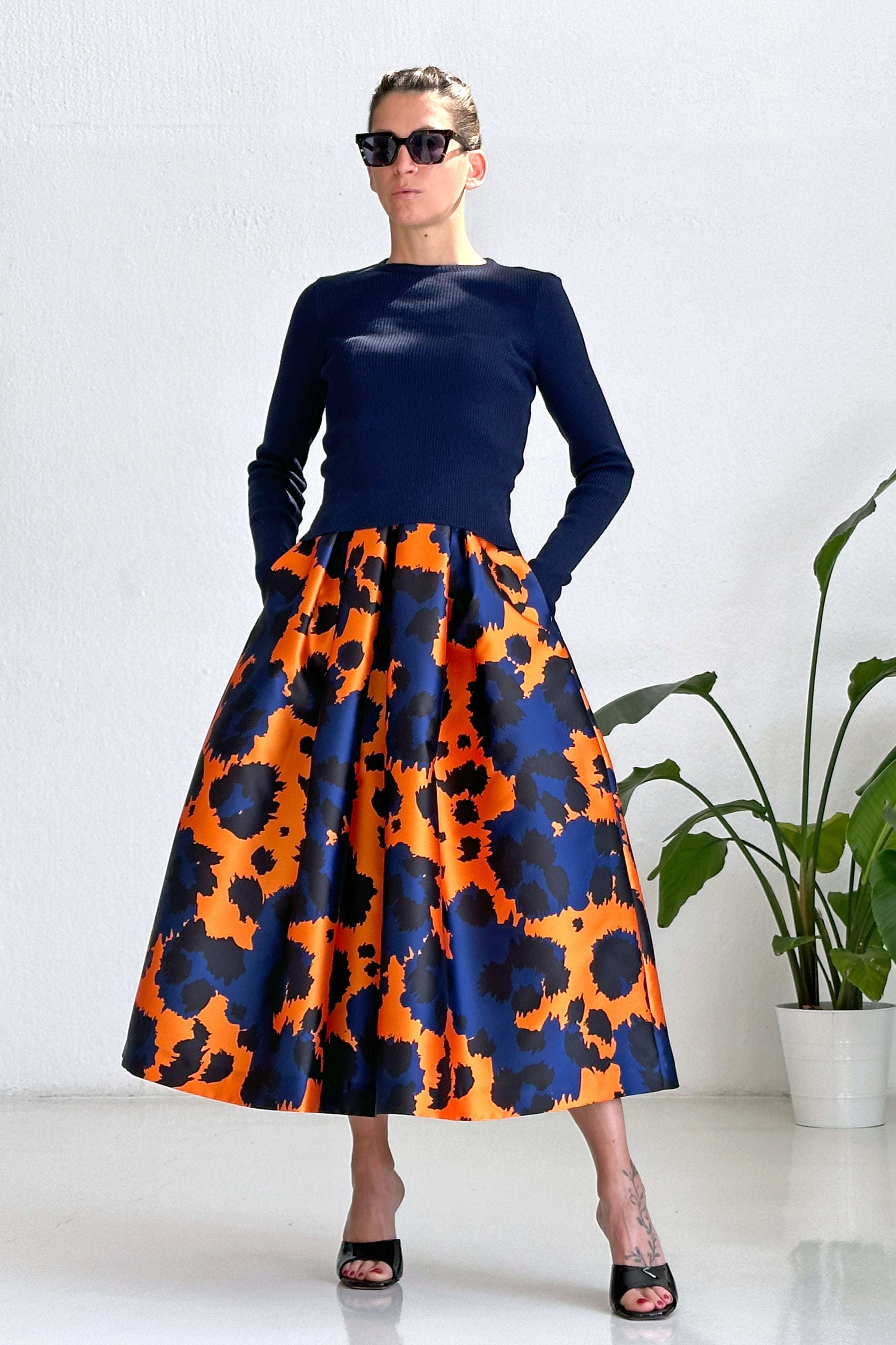 woman wearing orange and blue Animalier print midi skirt with high waist and long sleeves top