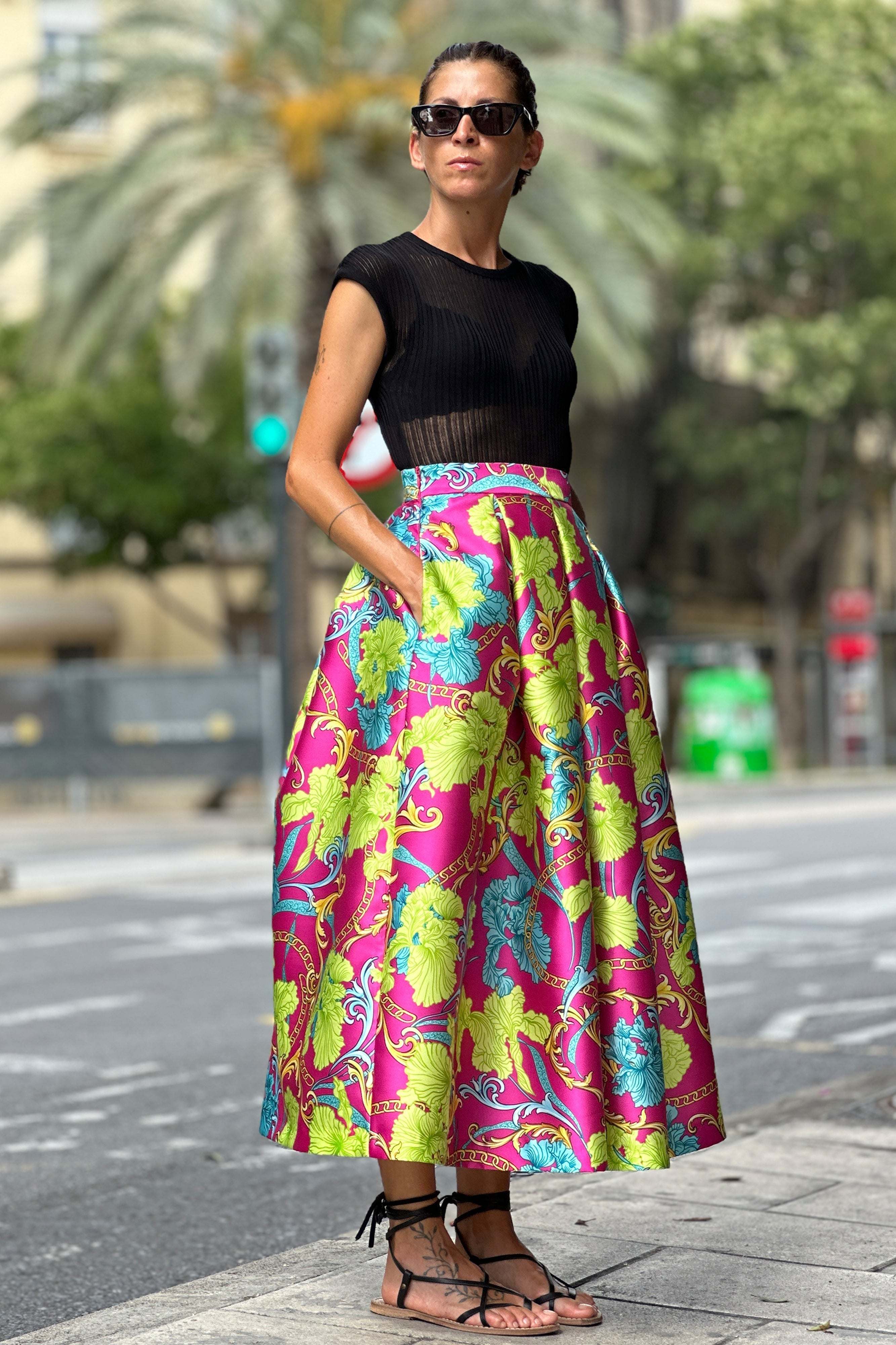 Woman wearing colorful midi Gonna Chains skirt with floral mikado fabric and high waist outdoors