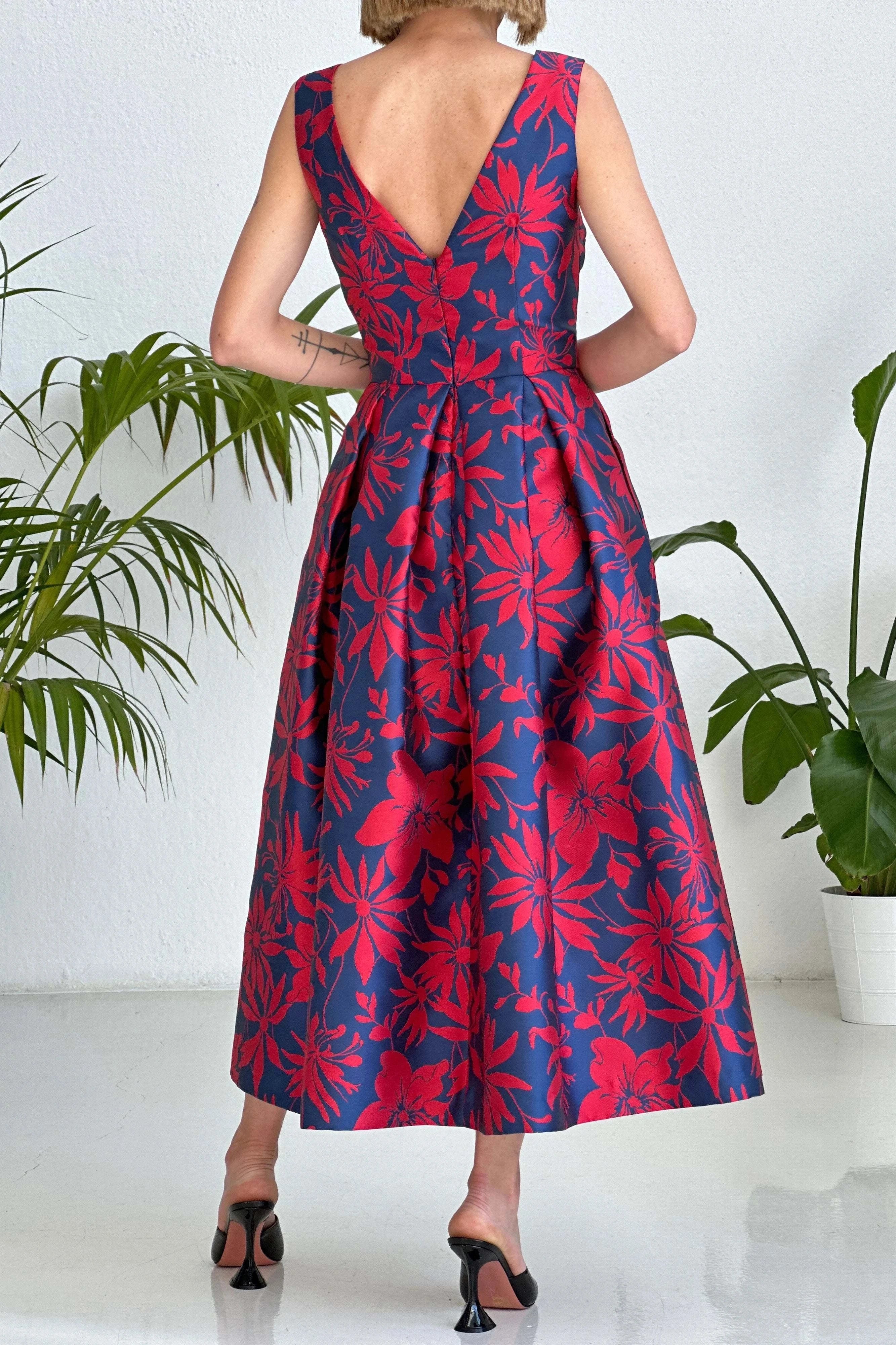 Red and blue floral jacquard V-neck sleeveless dress with pleated skirt and pockets, back view