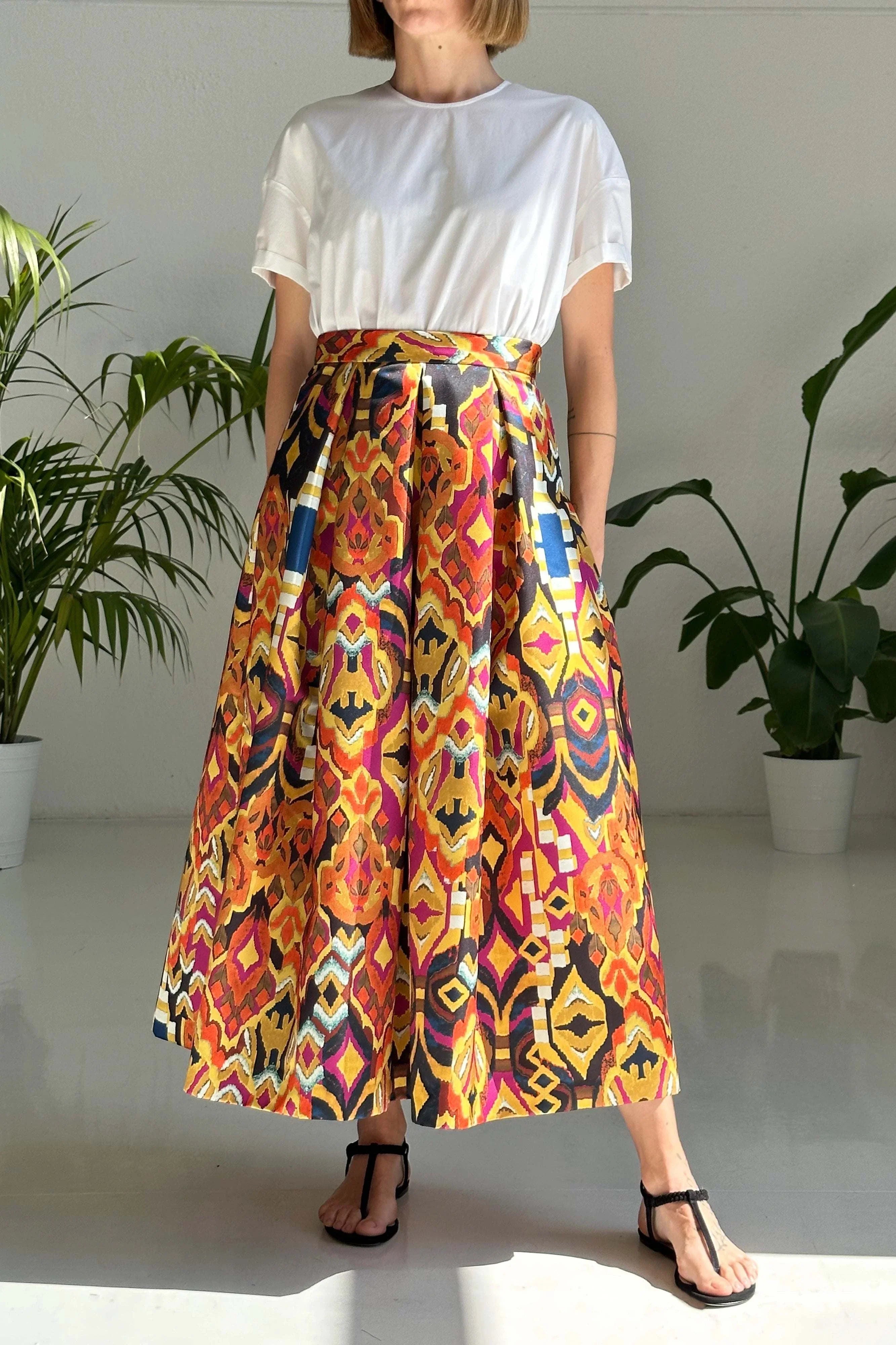 Woman wearing high-waisted midi skirt with tribal print and pockets
